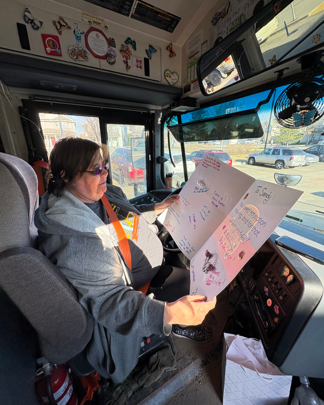 Bus driver reading card from students